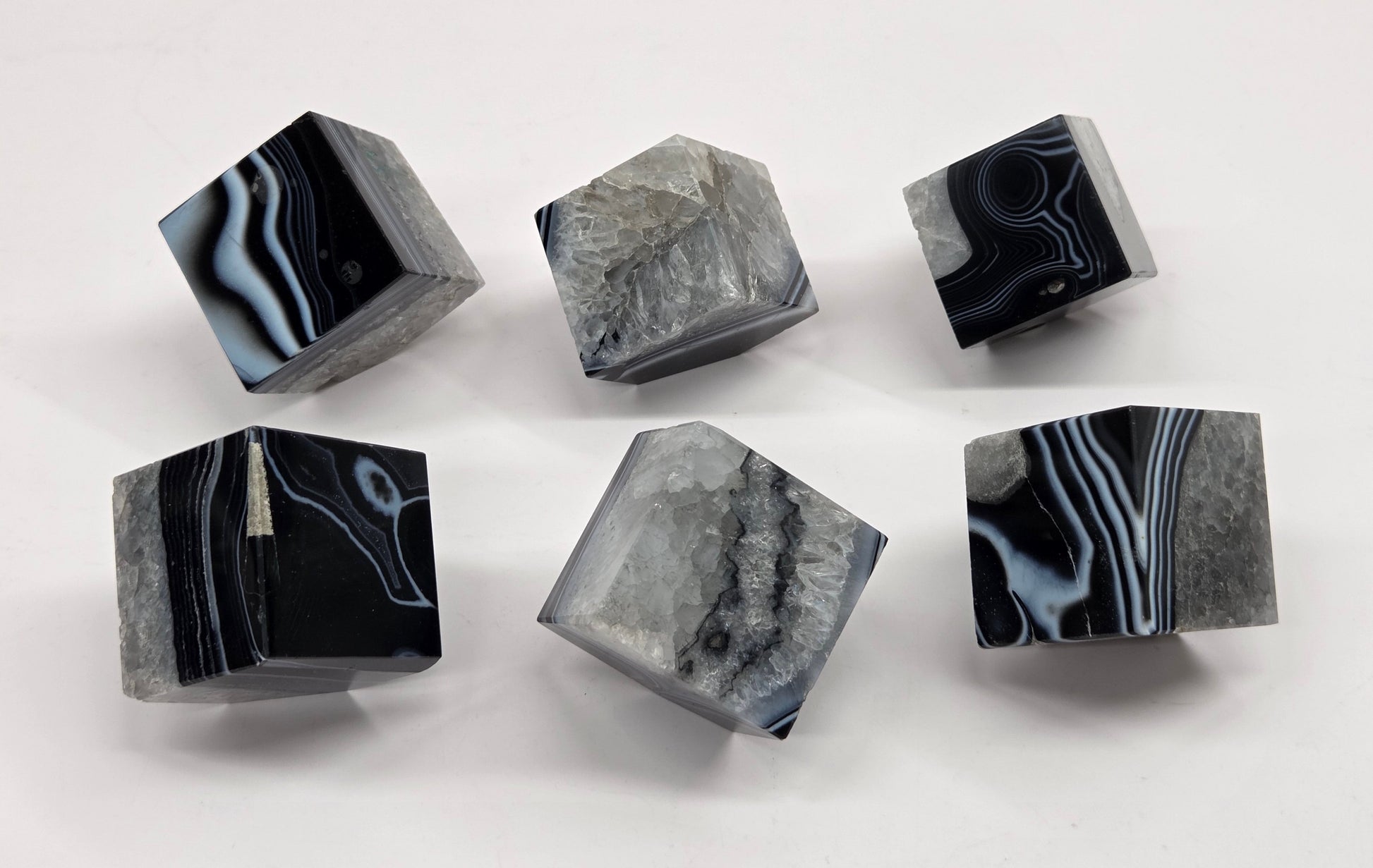 Black Agate cube shapes with black and white banding and quartz on a white background