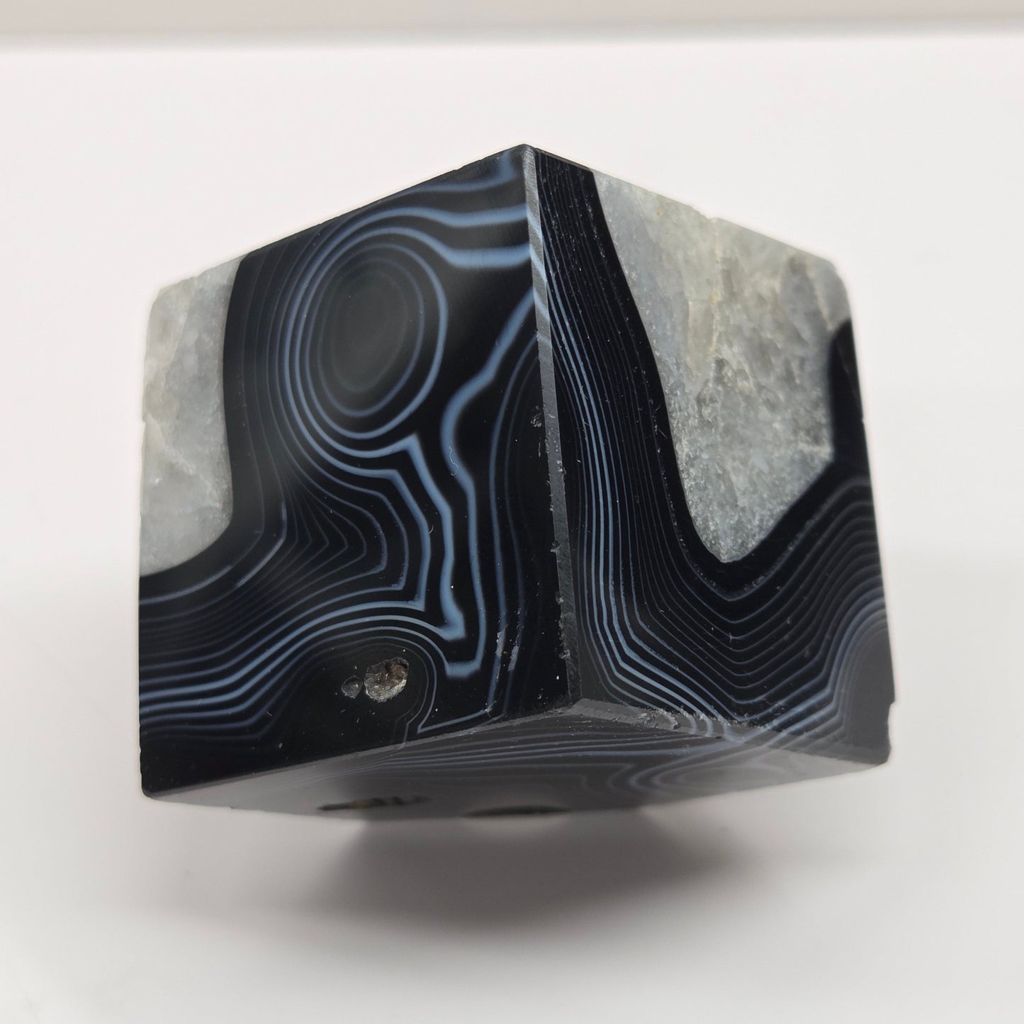 Black Agate cube shape with black and white banding and quartz on a white background