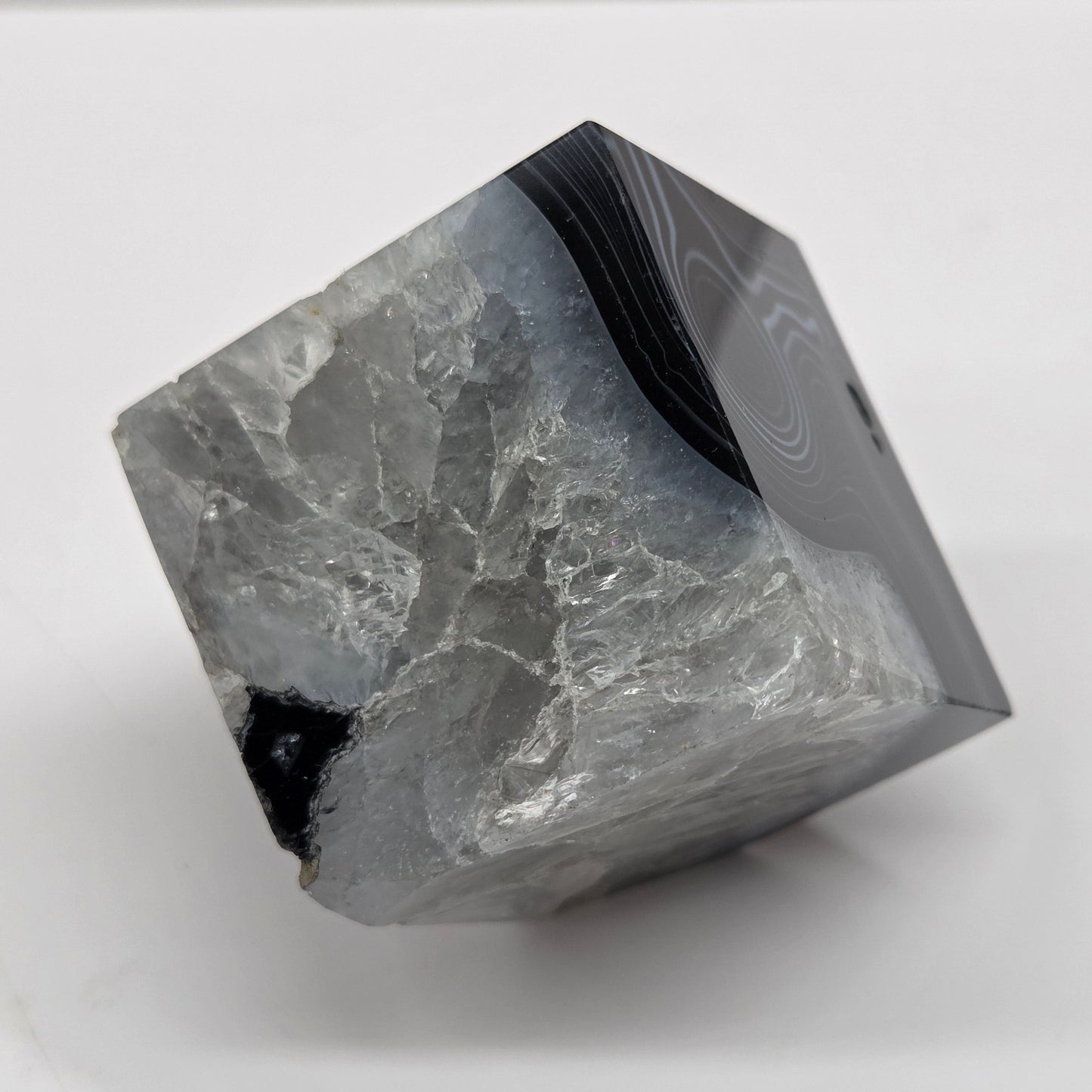 Black Agate cube shape with black and white banding and quartz on a white background