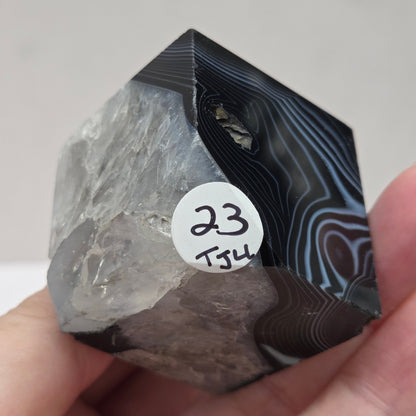Black Agate cube shape with black and white banding and quartz on a white background