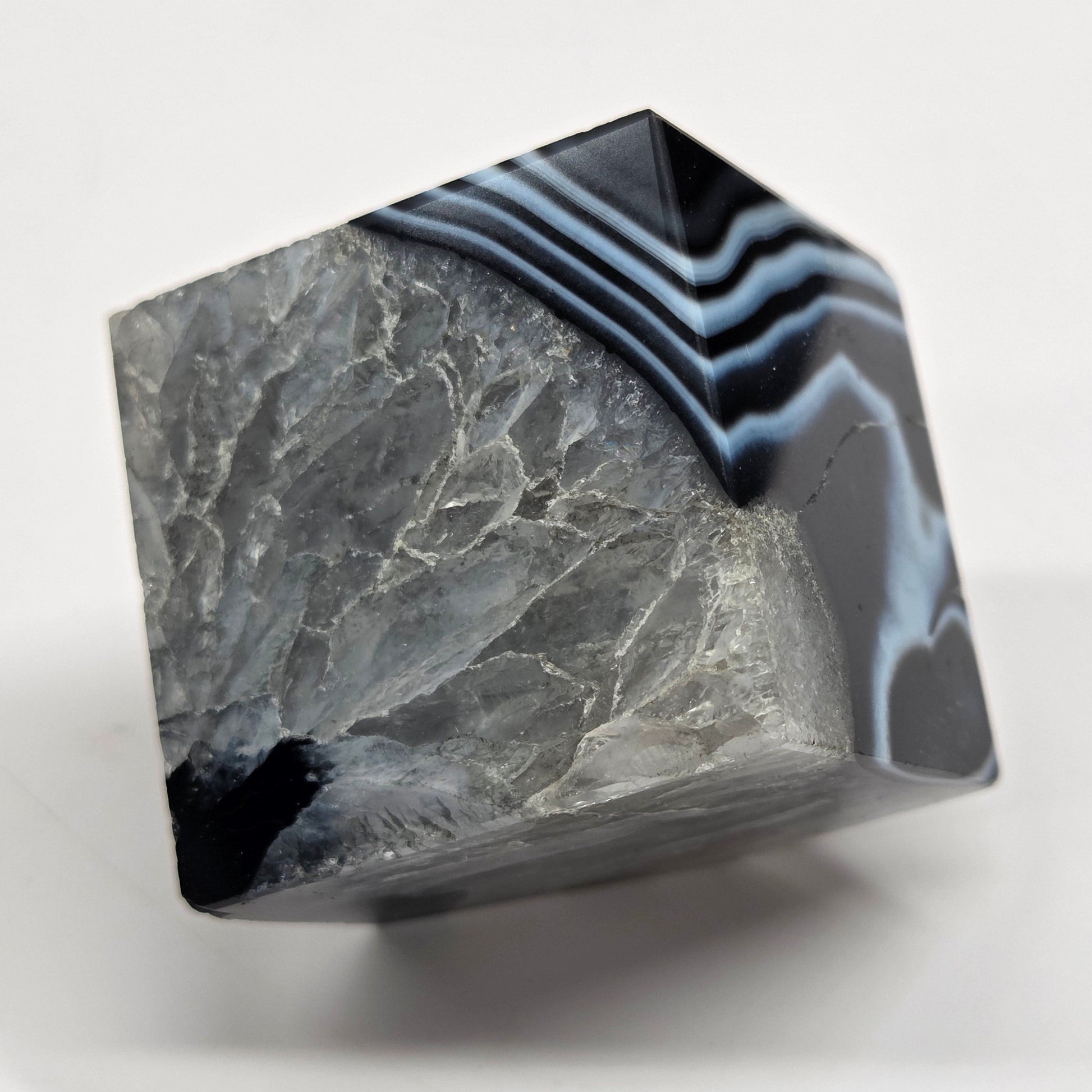 Black Agate cube shape with black and white banding and quartz on a white background