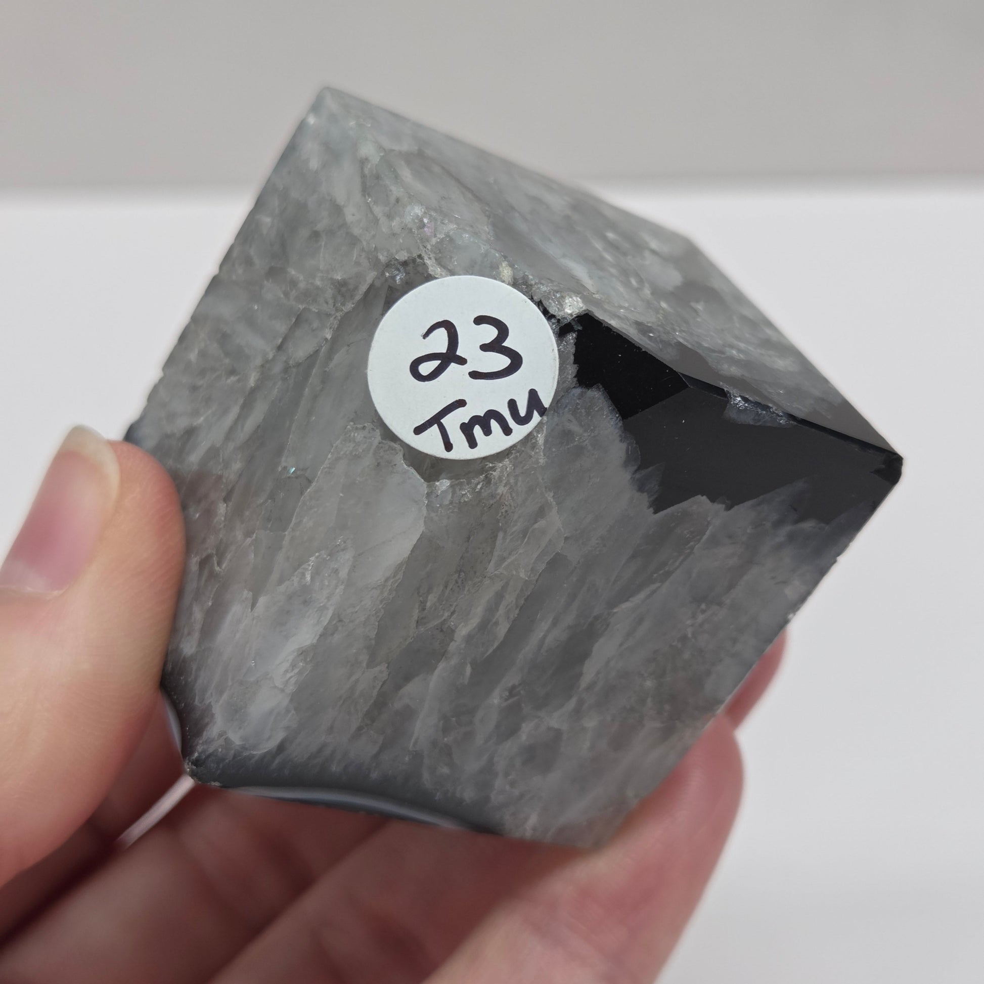 Black Agate cube shape with black and white banding and quartz on a white background