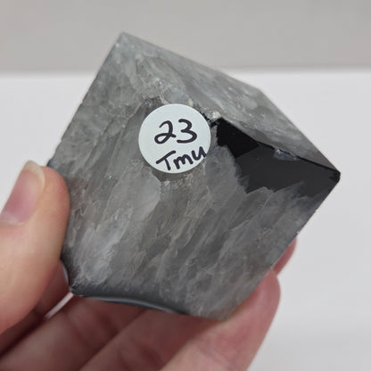 Black Agate cube shape with black and white banding and quartz on a white background