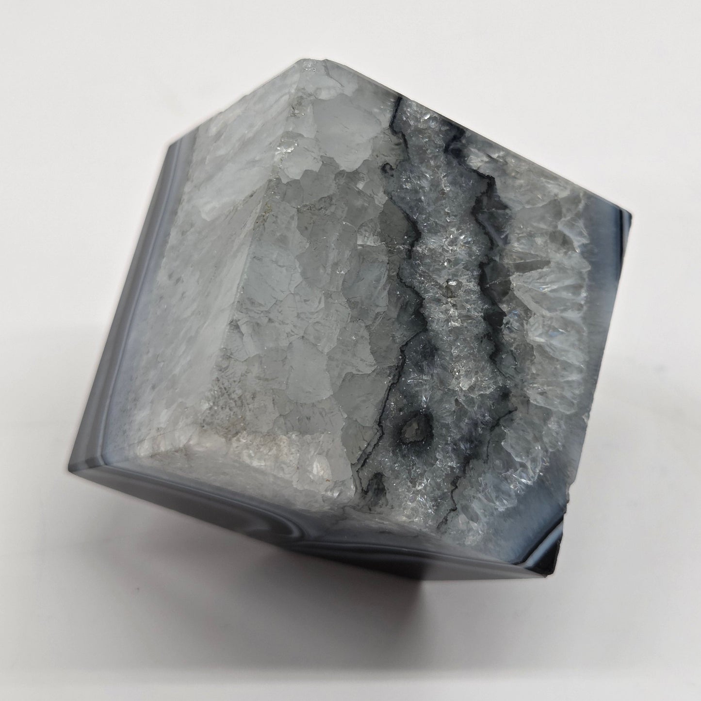 Black Agate cube shape with black and white banding and quartz on a white background