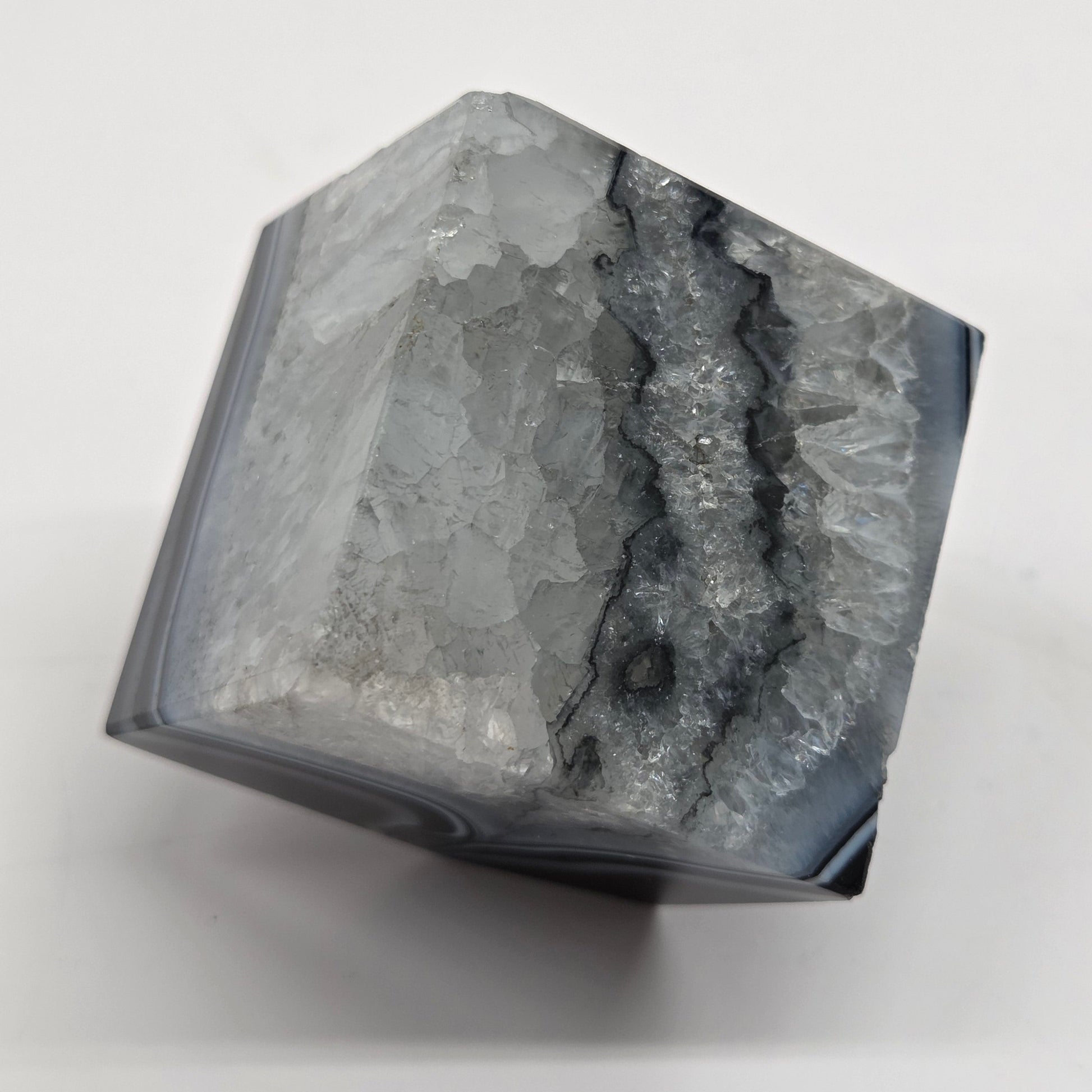 Black Agate cube shape with black and white banding and quartz on a white background