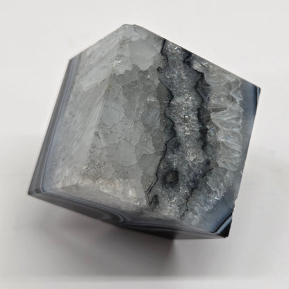 Black Agate cube shape with black and white banding and quartz on a white background