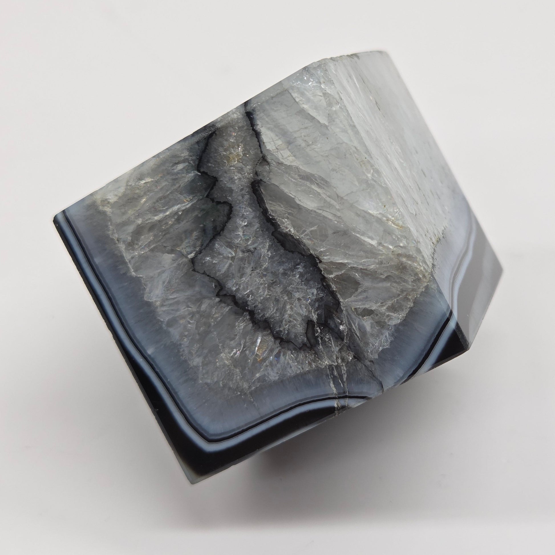 Black Agate cube shape with black and white banding and quartz on a white background