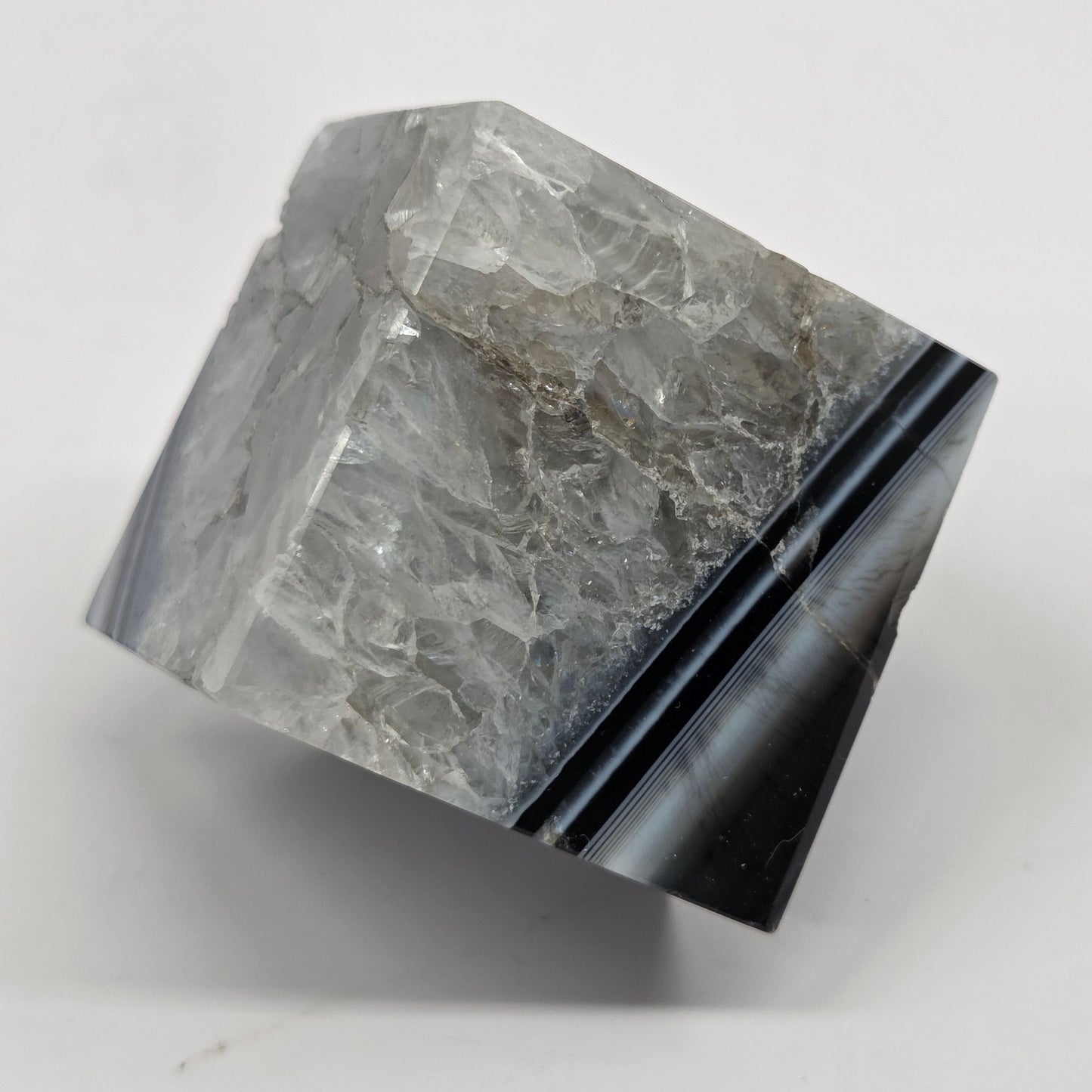 Black Agate cube shape with black and white banding and quartz on a white background