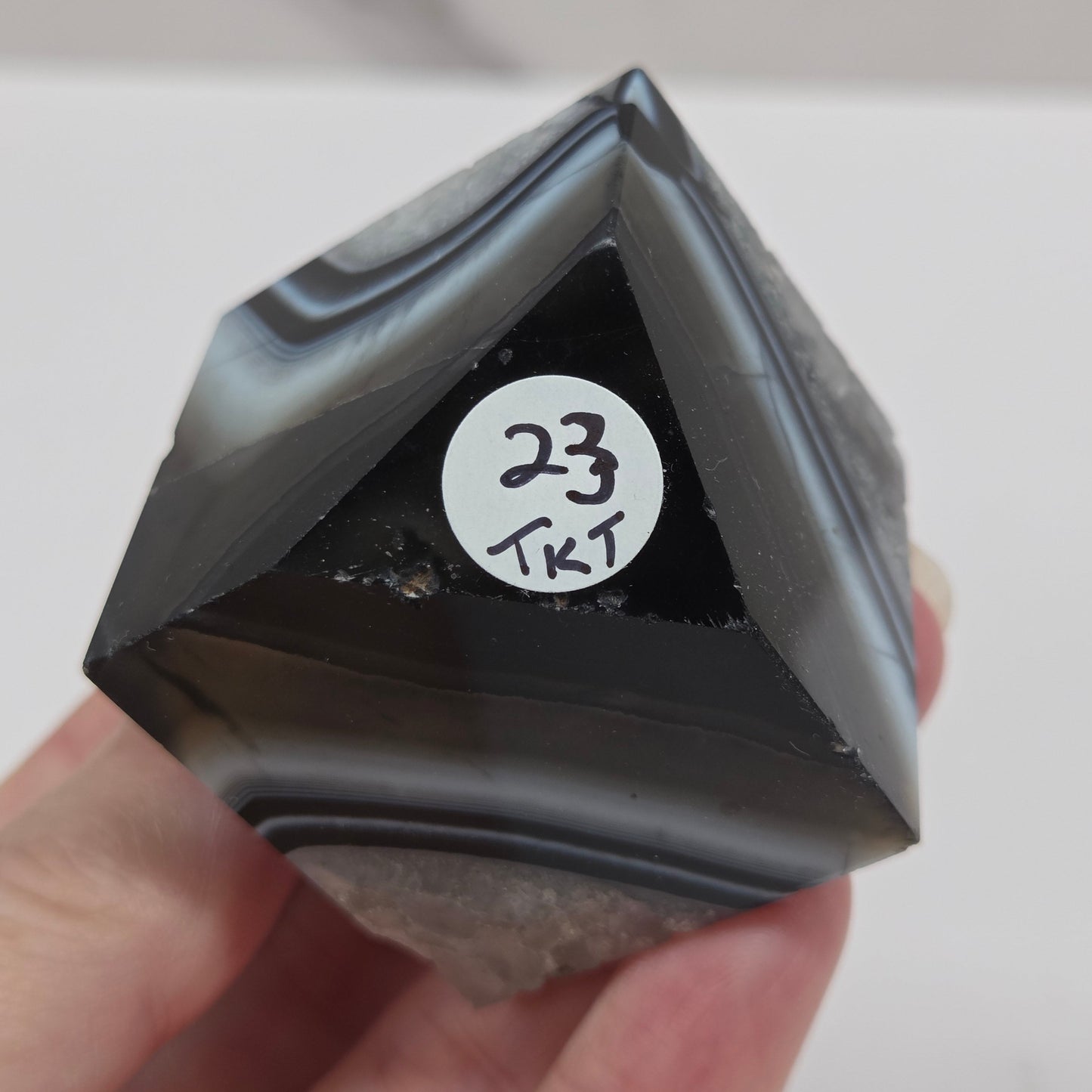 Black Agate cube shape with black and white banding and quartz on a white background