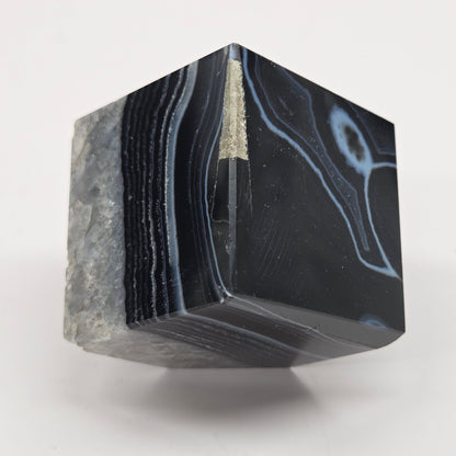 Black Agate cube shape with black and white banding and quartz on a white background