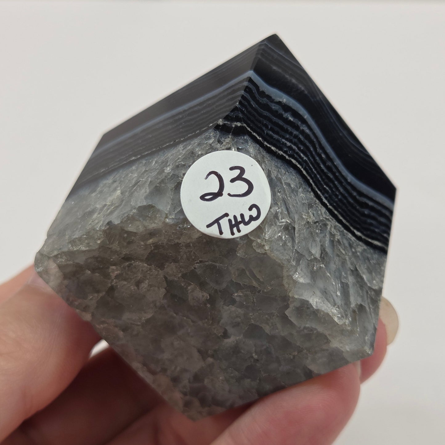 Black Agate cube shape with black and white banding and quartz on a white background