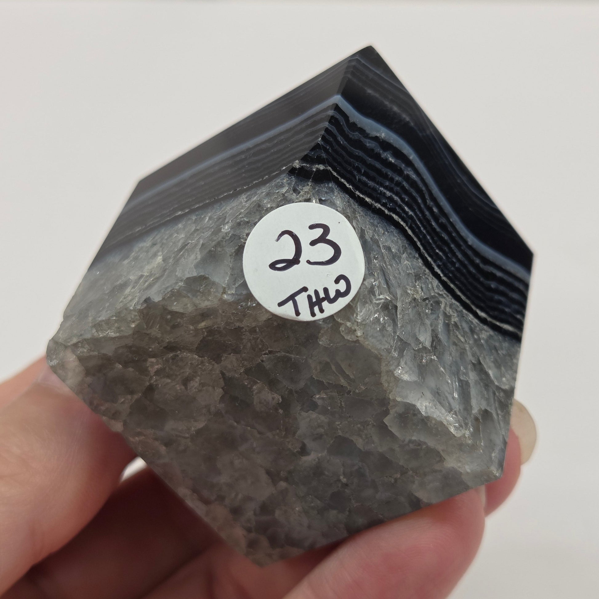 Black Agate cube shape with black and white banding and quartz on a white background