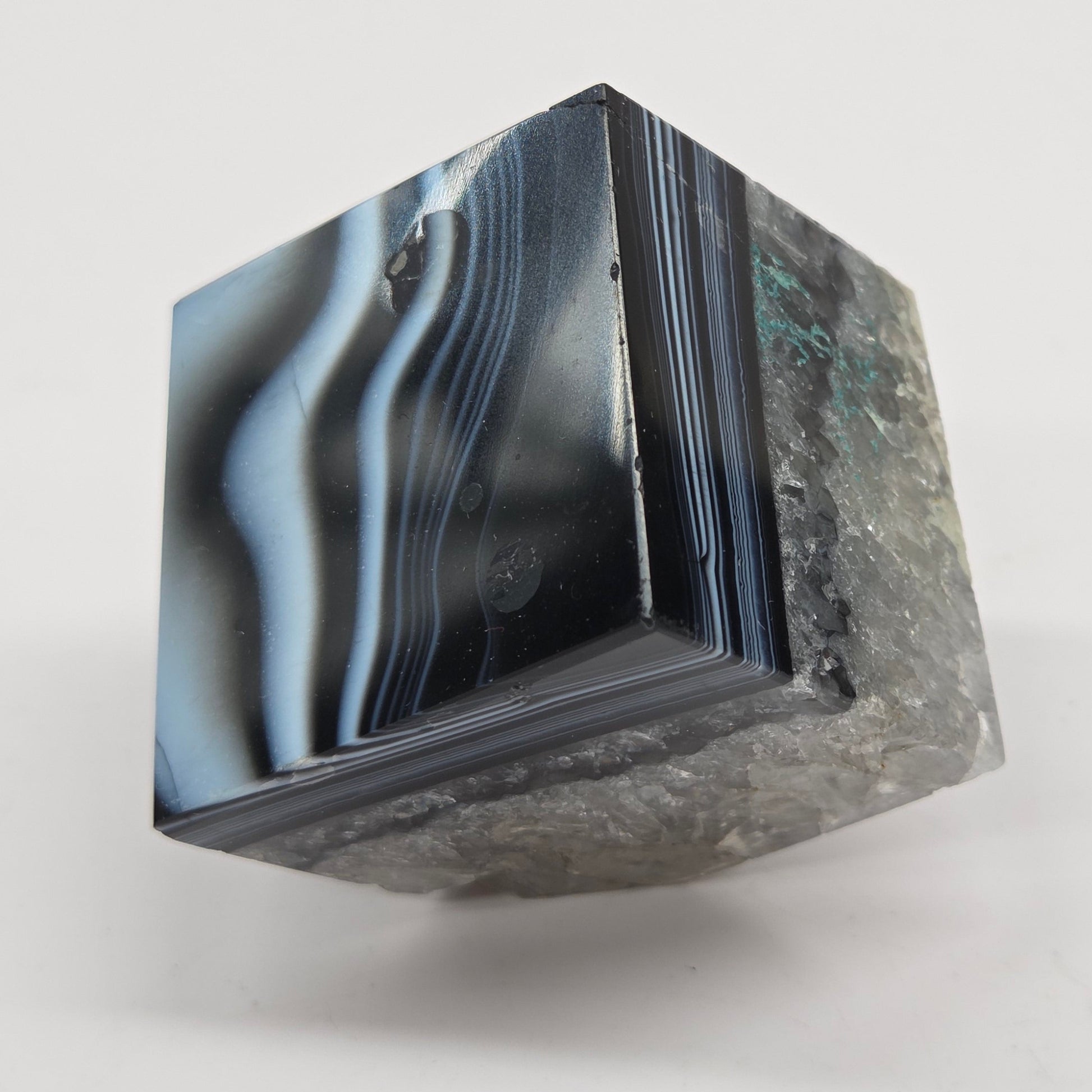 Black Agate cube shape with black and white banding and quartz on a white background