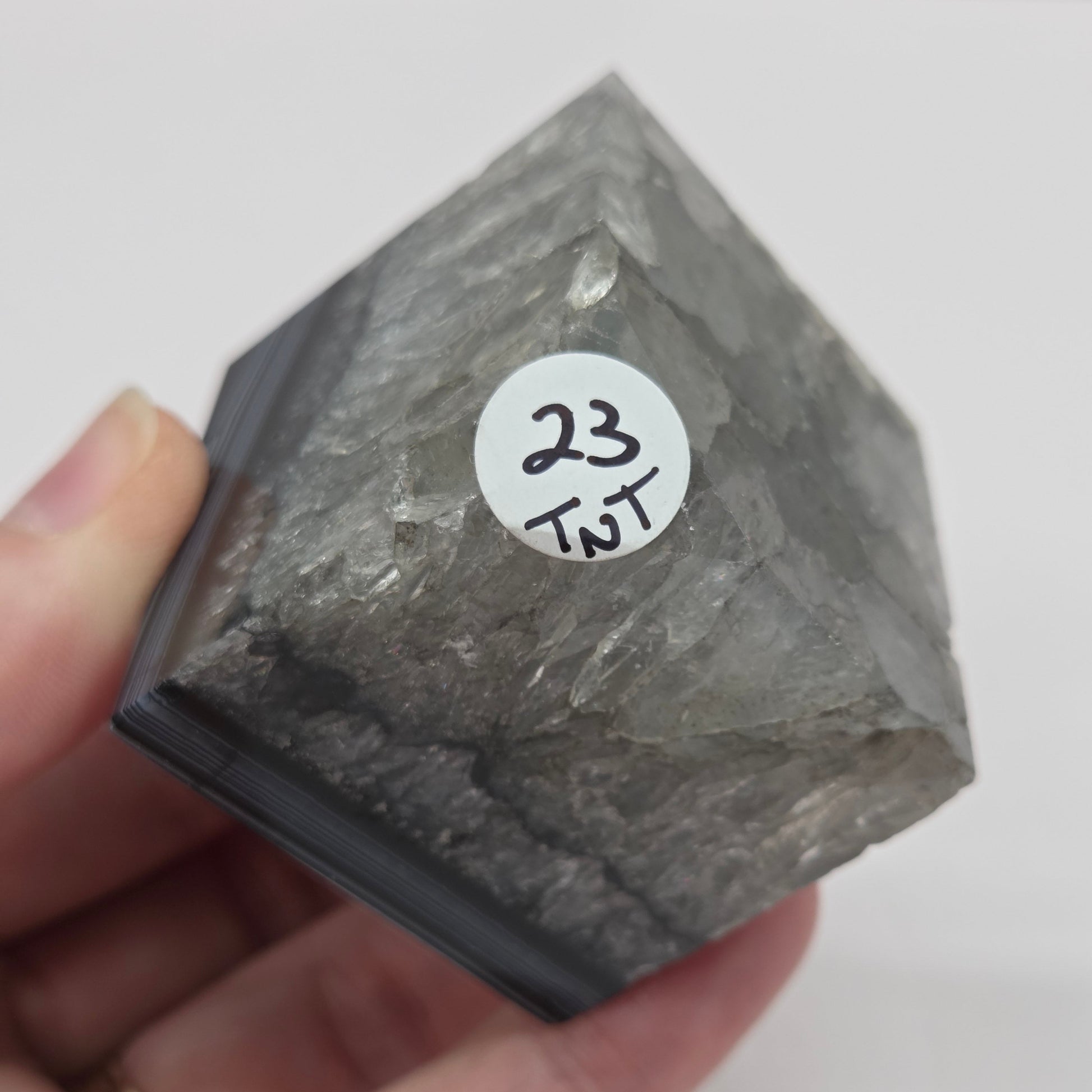 Black Agate cube shape with black and white banding and quartz on a white background