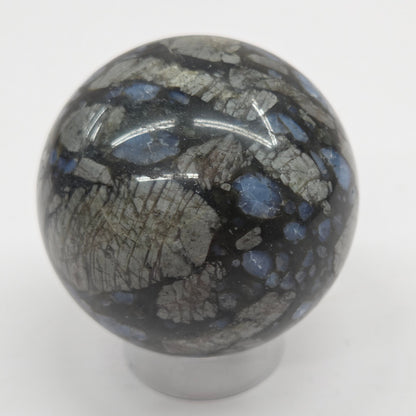 Blue grey and black sphere on an acrylic stand against a white background