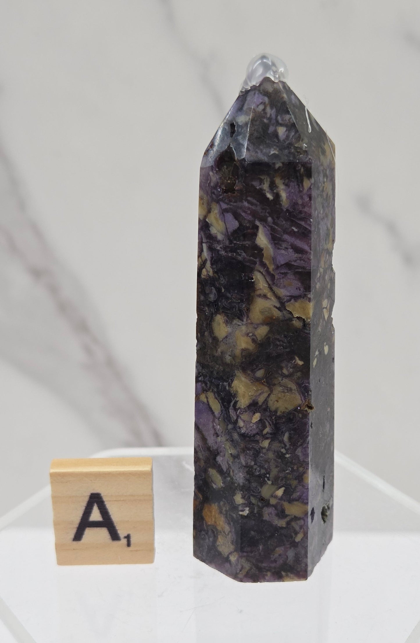 Brecciated Fluorite tower against a white background