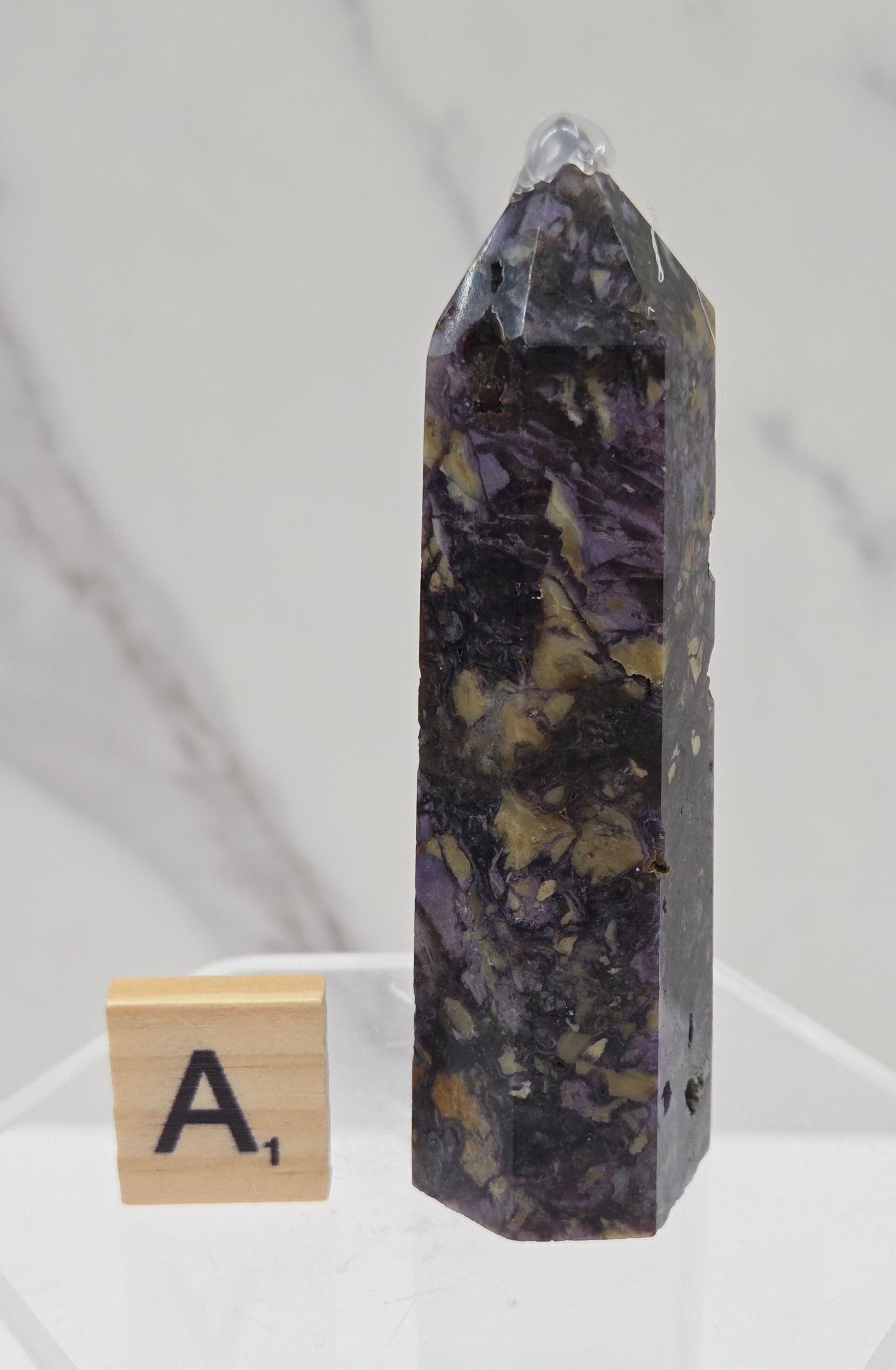 Brecciated Fluorite tower against a white background