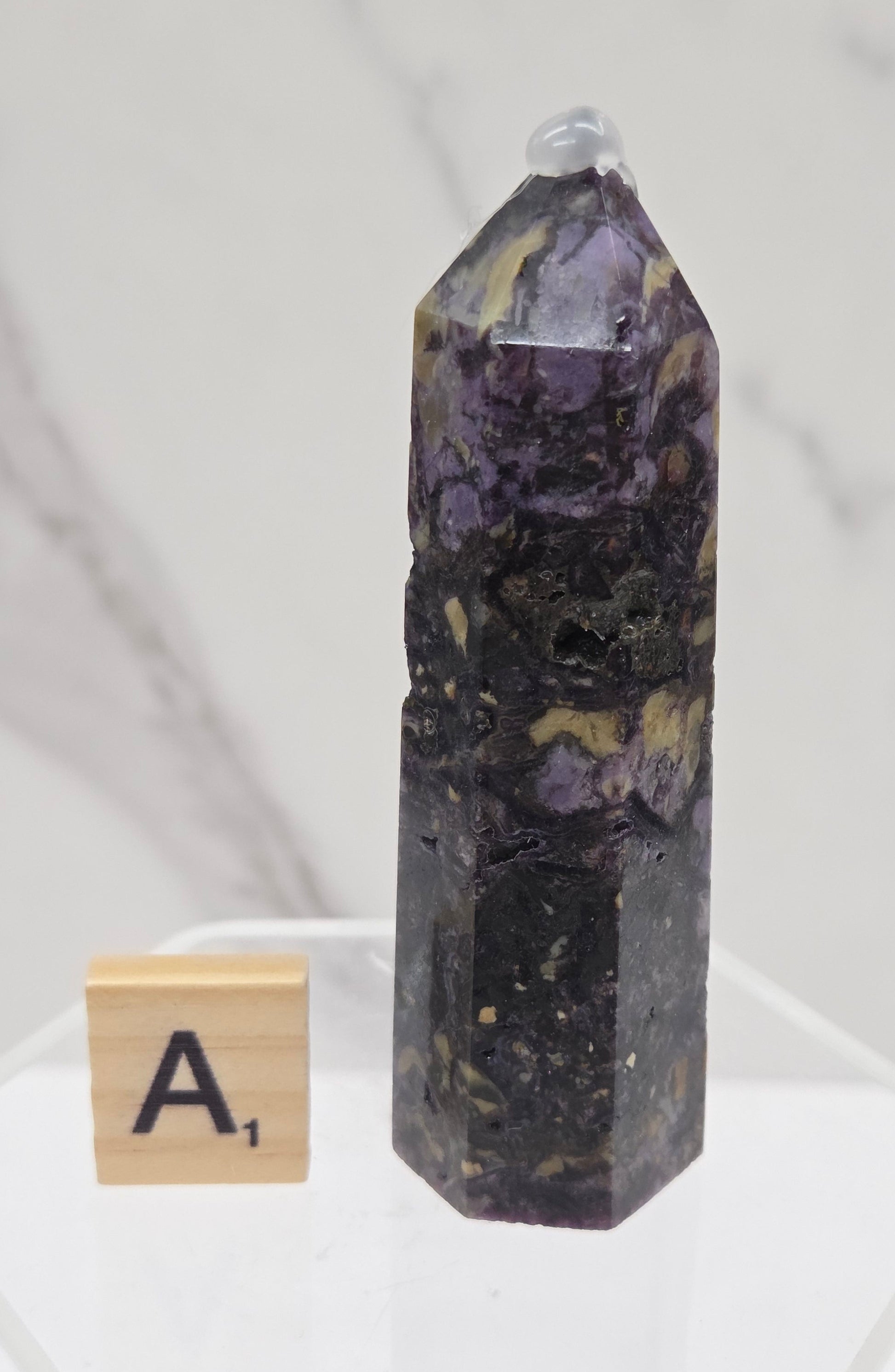 Brecciated Fluorite tower against a white background