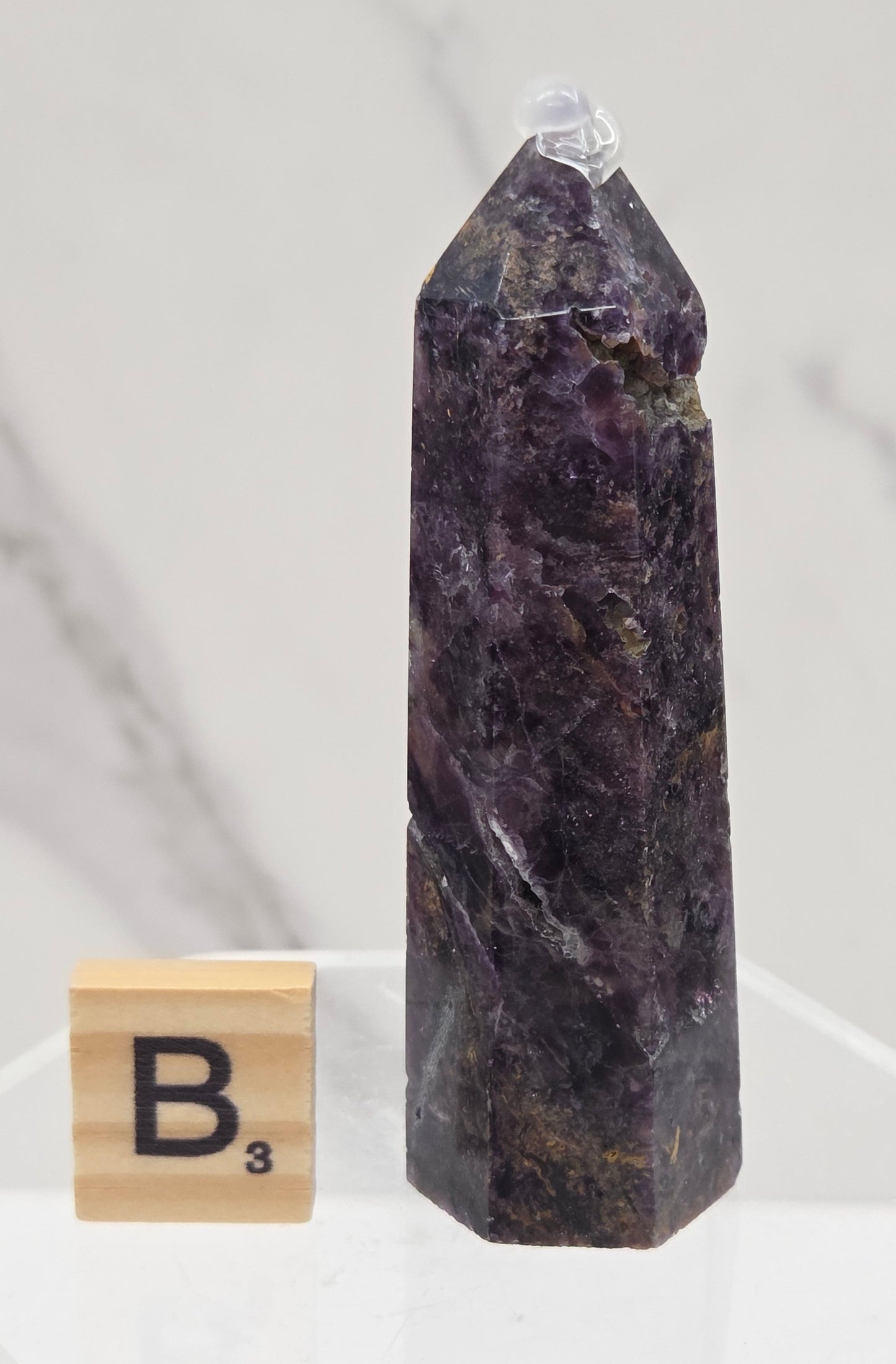 Brecciated Fluorite tower against a white background