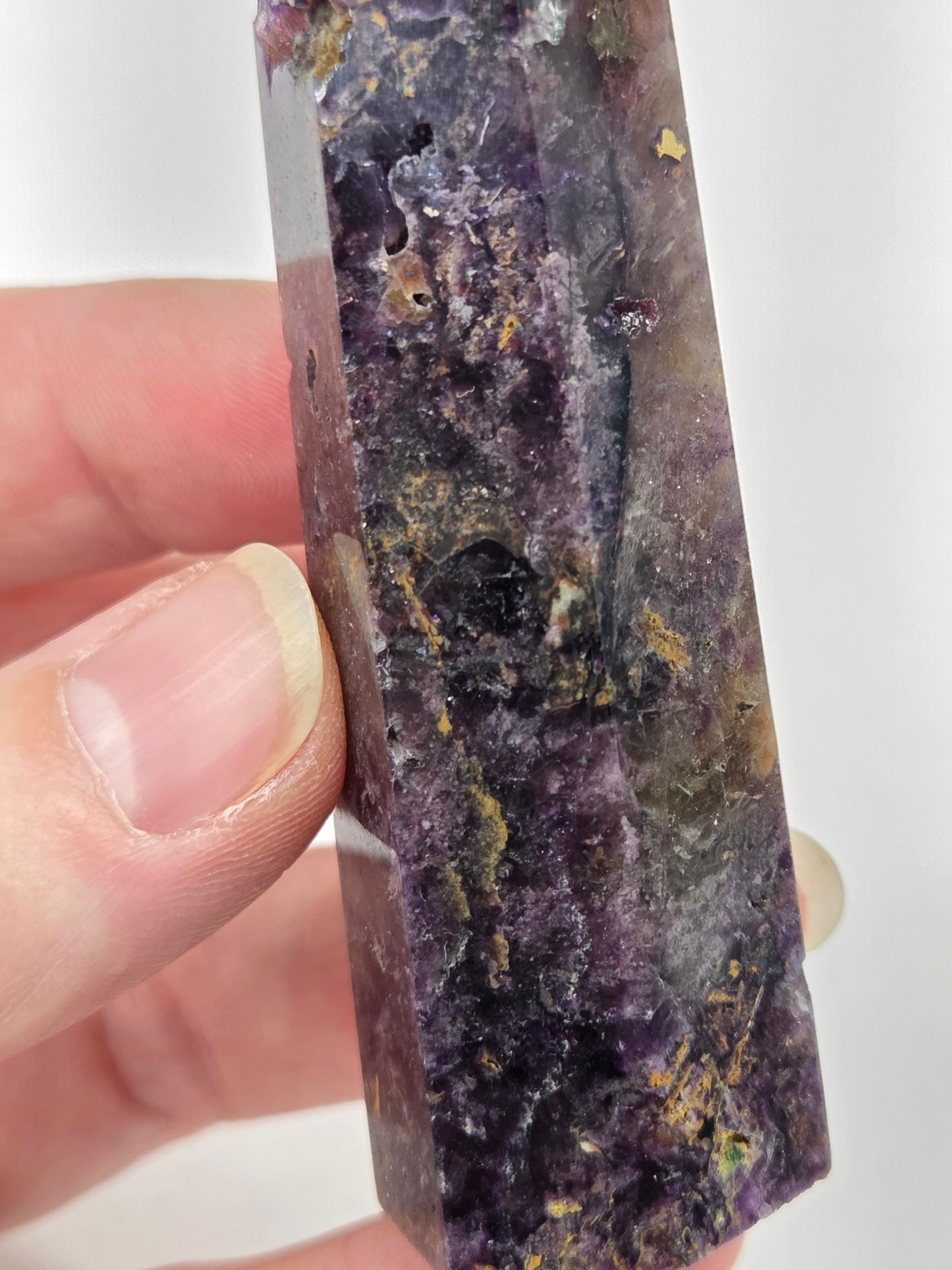 Brecciated Fluorite tower against a white background