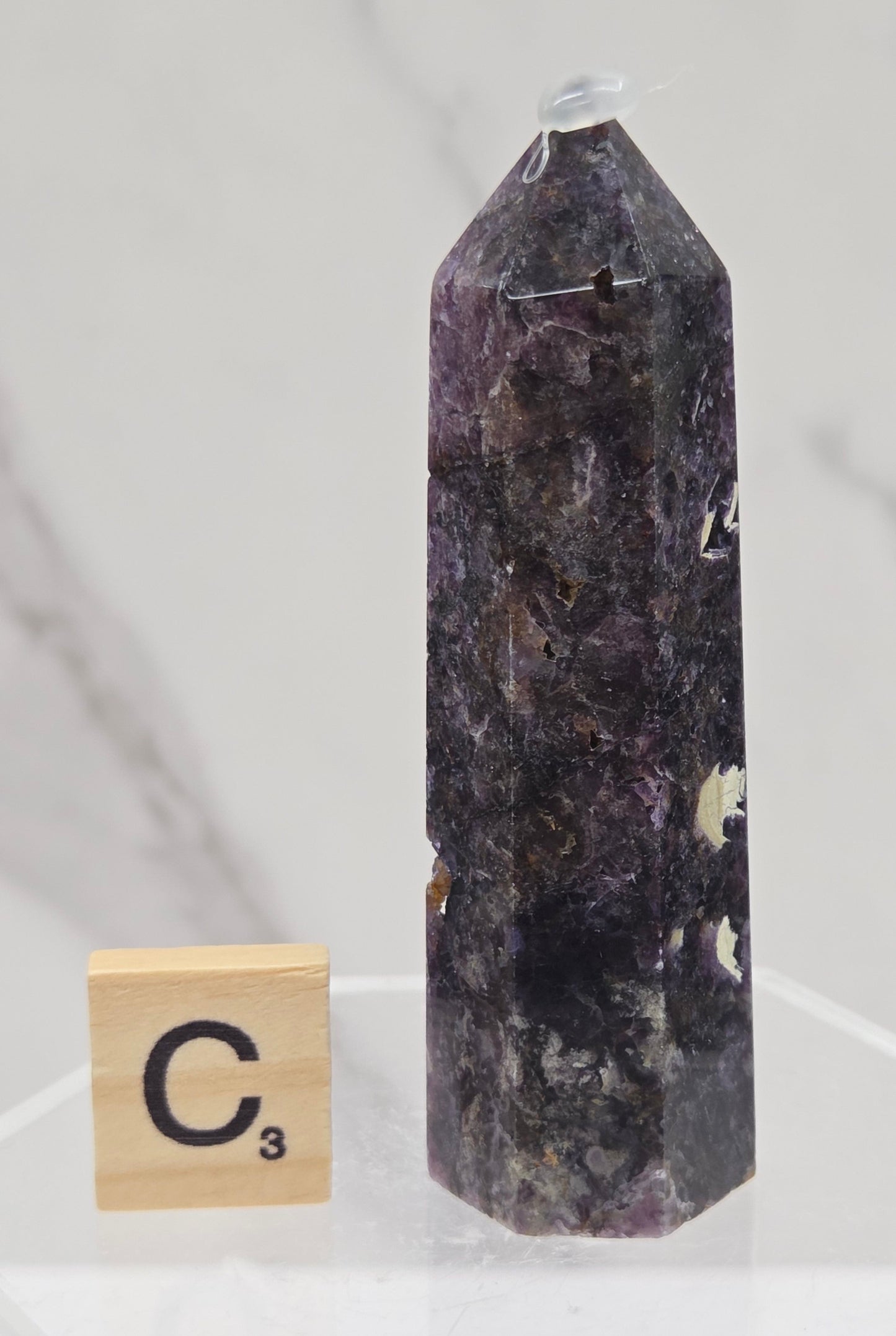 Brecciated Fluorite tower against a white background