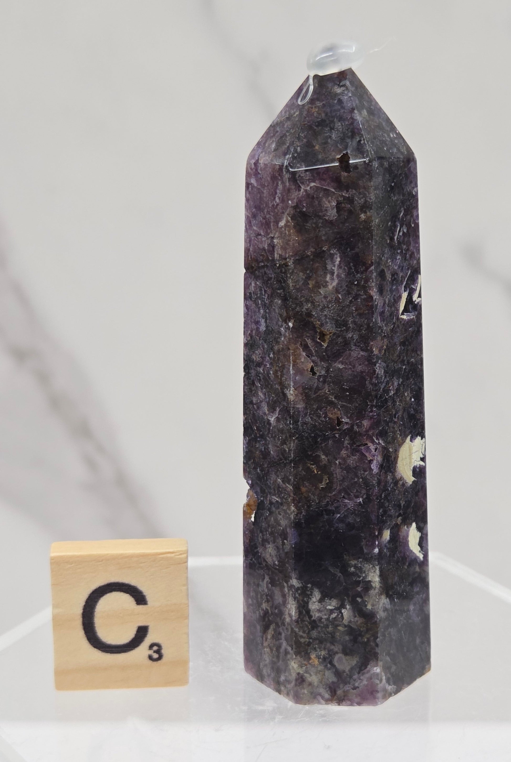 Brecciated Fluorite tower against a white background