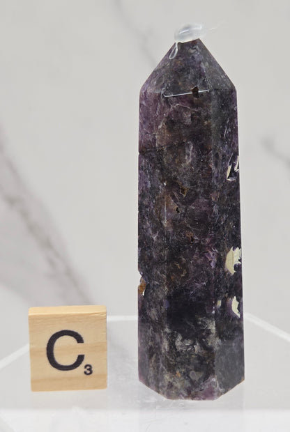 Brecciated Fluorite tower against a white background