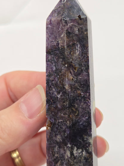 Brecciated Fluorite tower against a white background