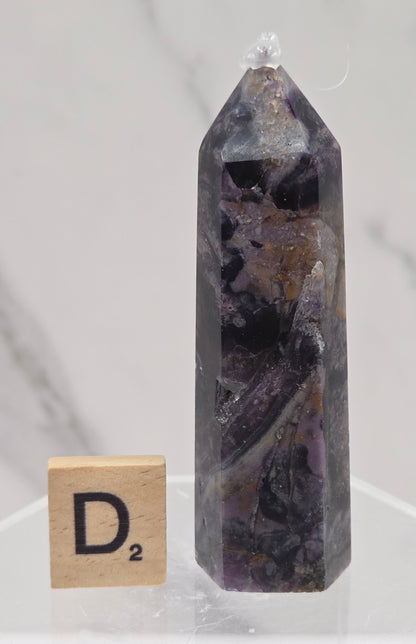 Brecciated Fluorite tower against a white background