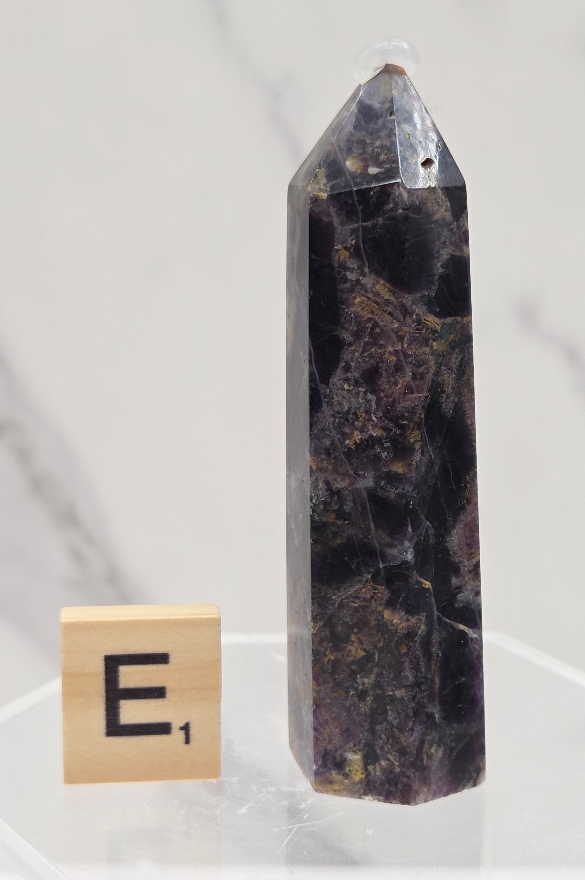 Brecciated Fluorite tower against a white background