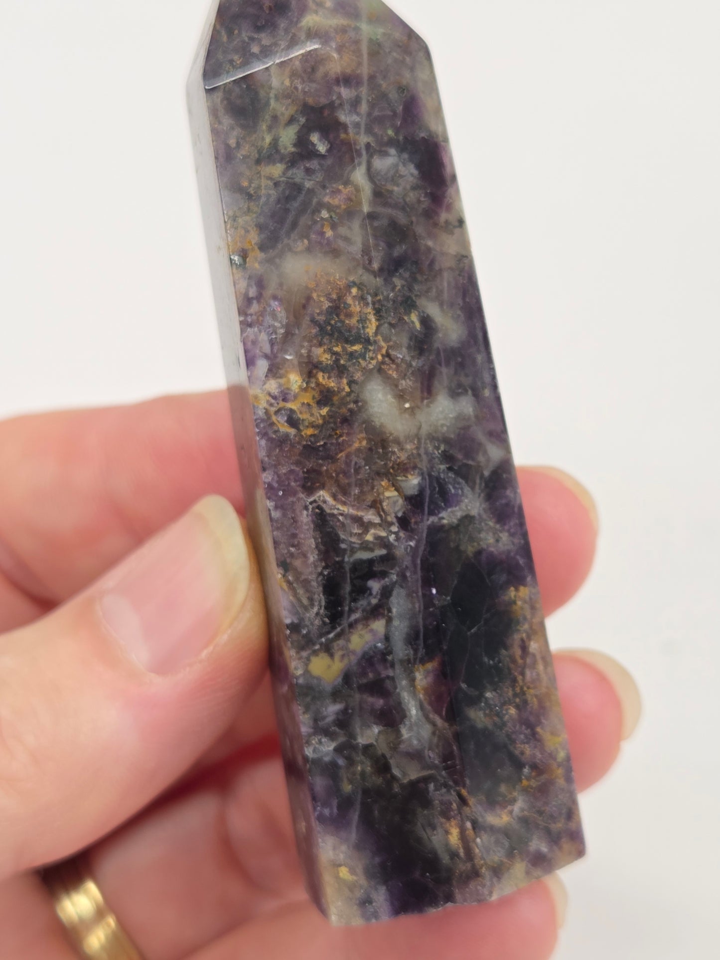 Brecciated Fluorite tower against a white background