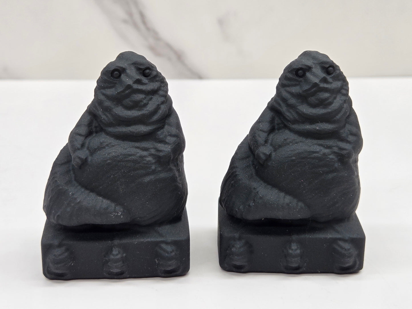 Obsidian Jabba the Hut, from Star Wars, carvings on a white background