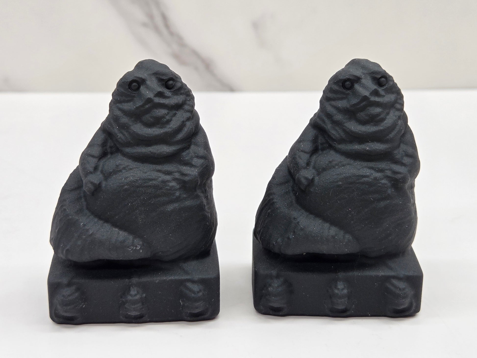 Obsidian Jabba the Hut, from Star Wars, carvings on a white background
