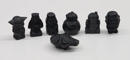Set of 7 Star Wars character carvings made of Obsidian on a white background