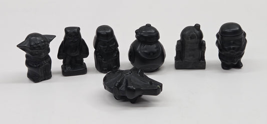 Set of 7 Star Wars character carvings made of Obsidian on a white background