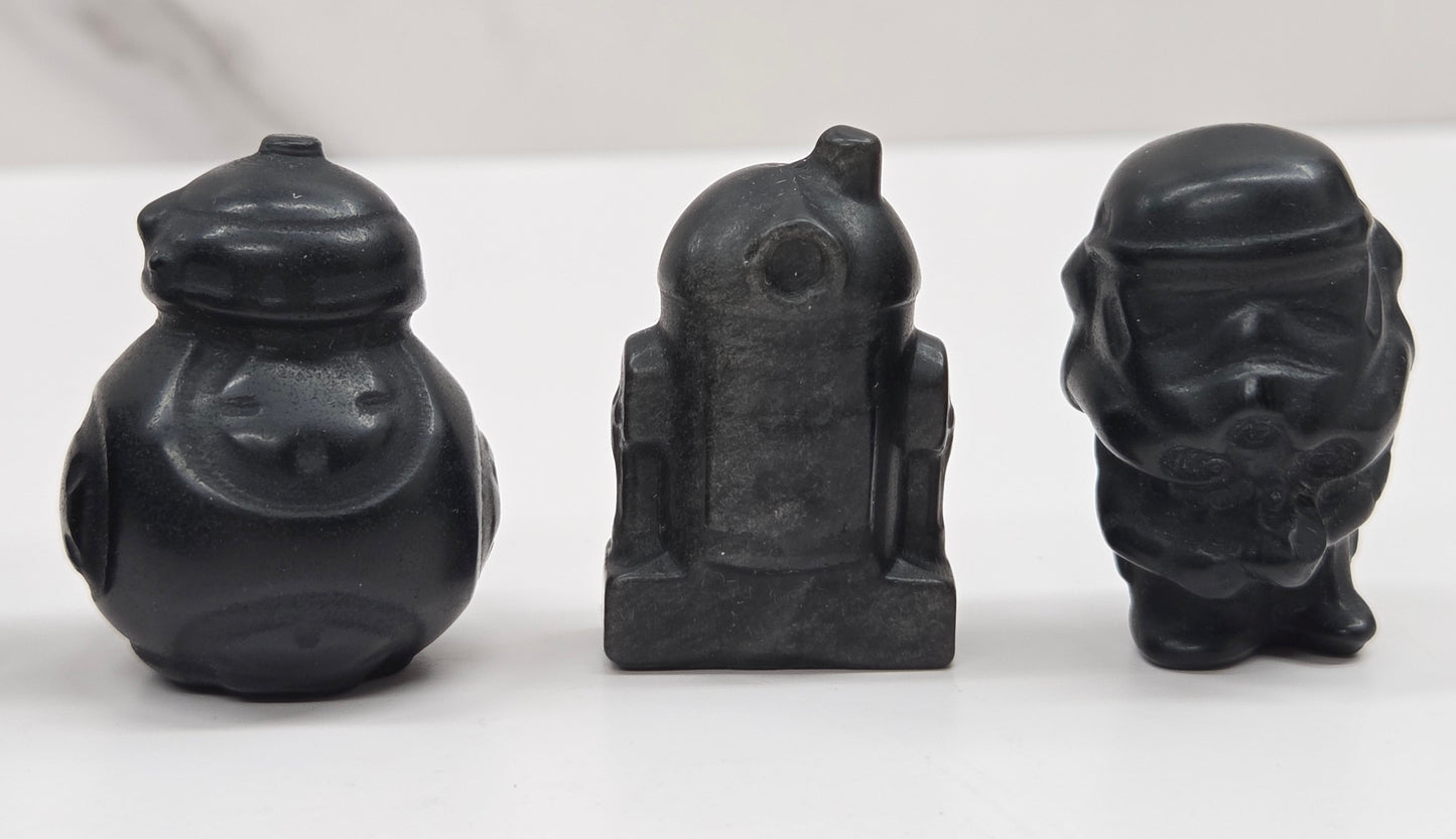 Set of Star Wars character carvings made of Obsidian on a white background