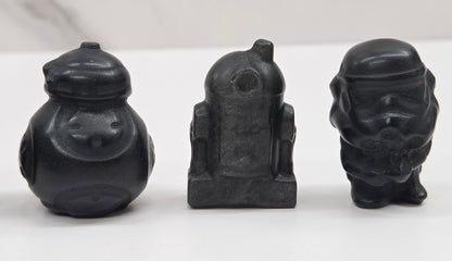 Set of Star Wars character carvings made of Obsidian on a white background