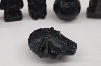 Set of Star Wars character carvings made of Obsidian on a white background