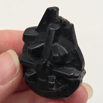 Star Wars Millennium Falcon carving made of Obsidian on a white background
