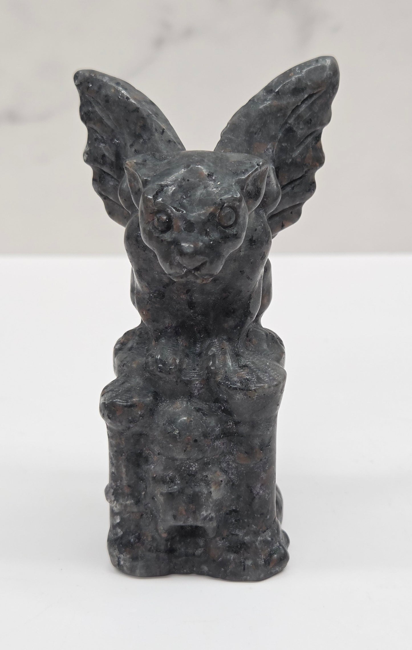 Yooperlite gargoyle carving on a white surface