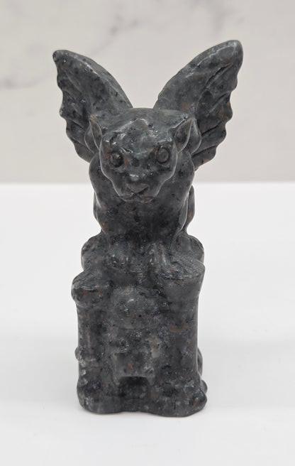Yooperlite gargoyle carving on a white surface