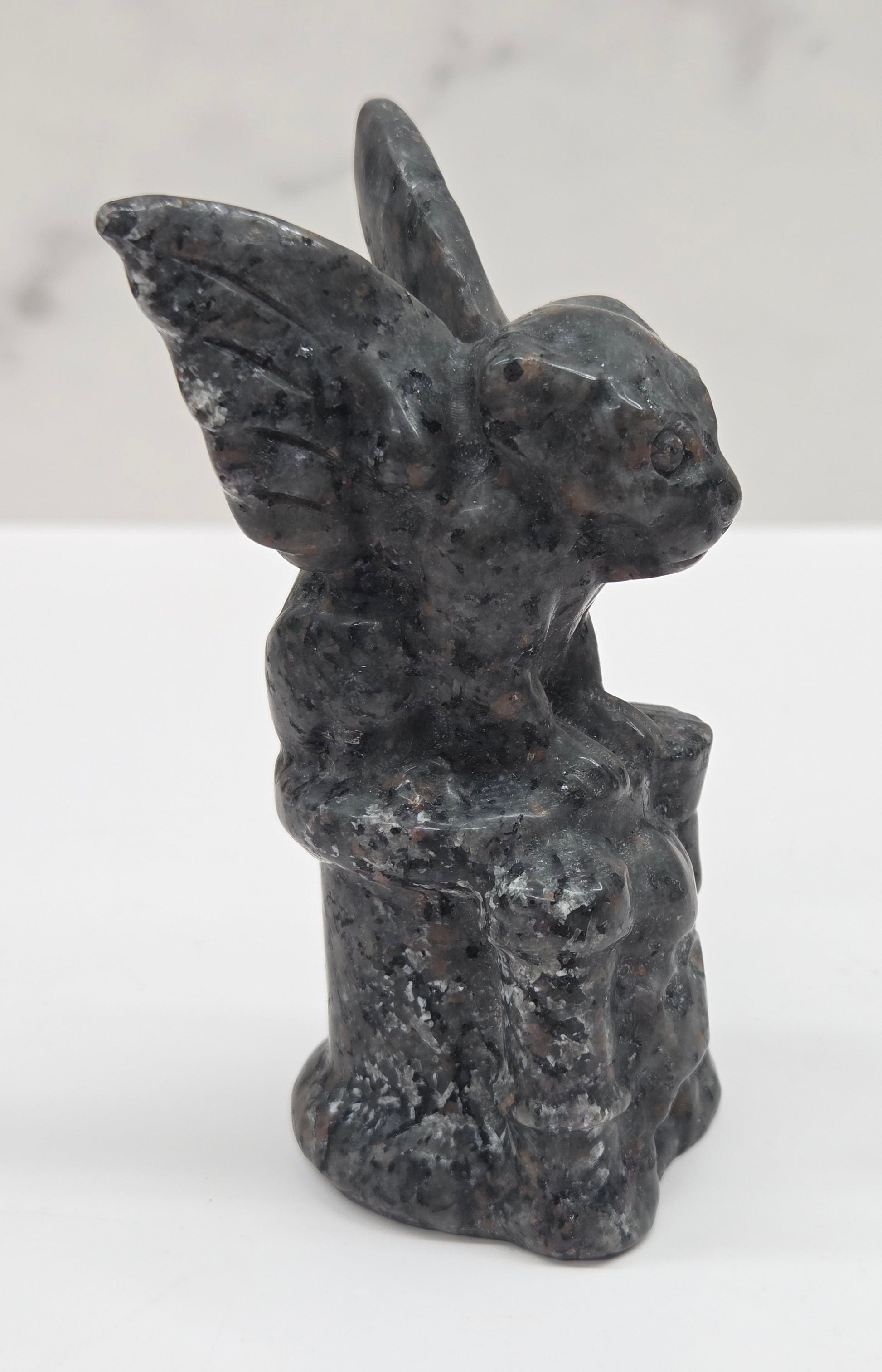 Yooperlite gargoyle carving on a white surface