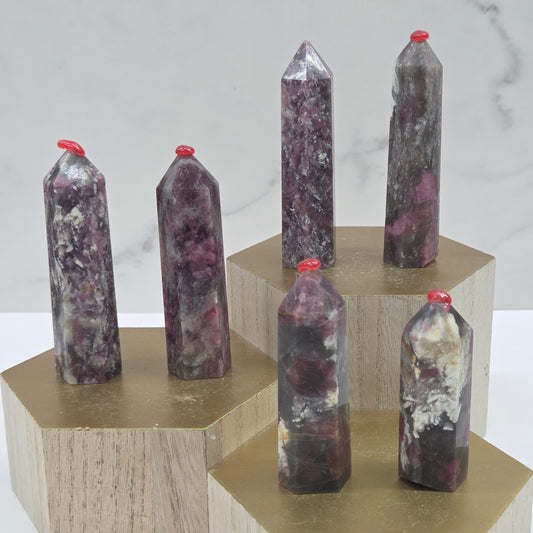 Crystal points on a wooden stand against a marble background