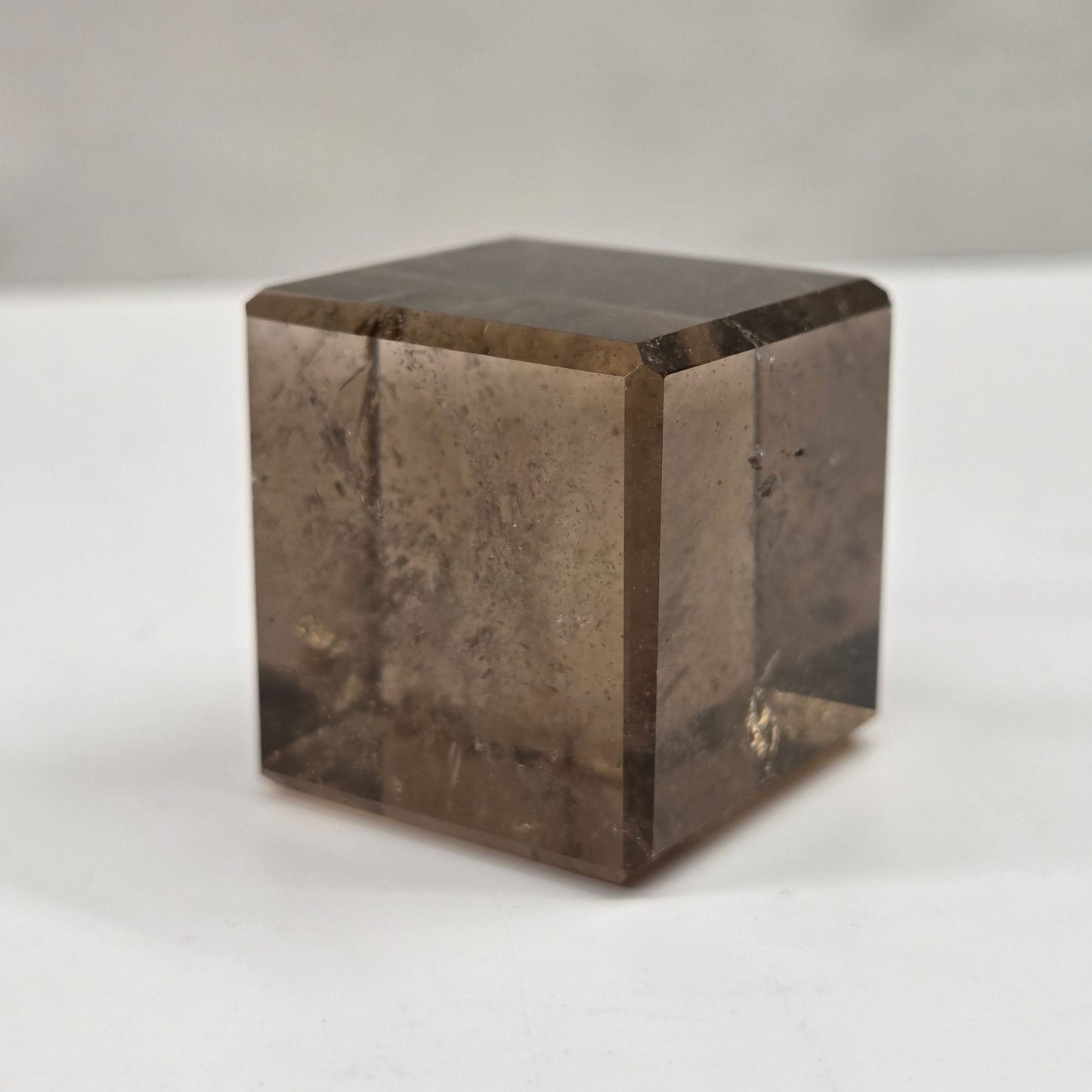 smoky quartz cube carving on a white background