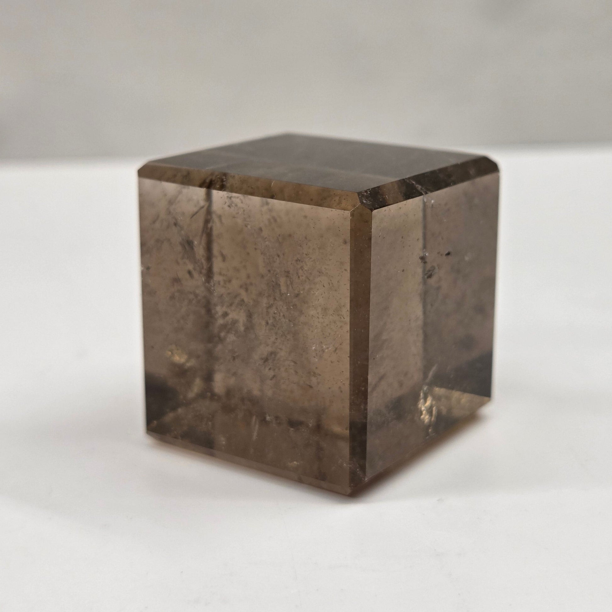 smoky quartz cube carving on a white background