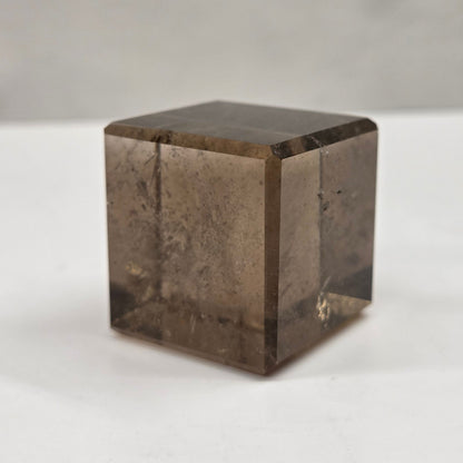smoky quartz cube carving on a white background