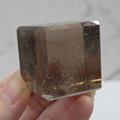 smoky quartz cube carving on a white background