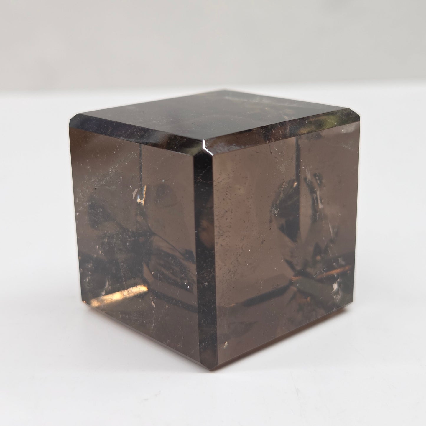 smoky quartz cube carving on a white background
