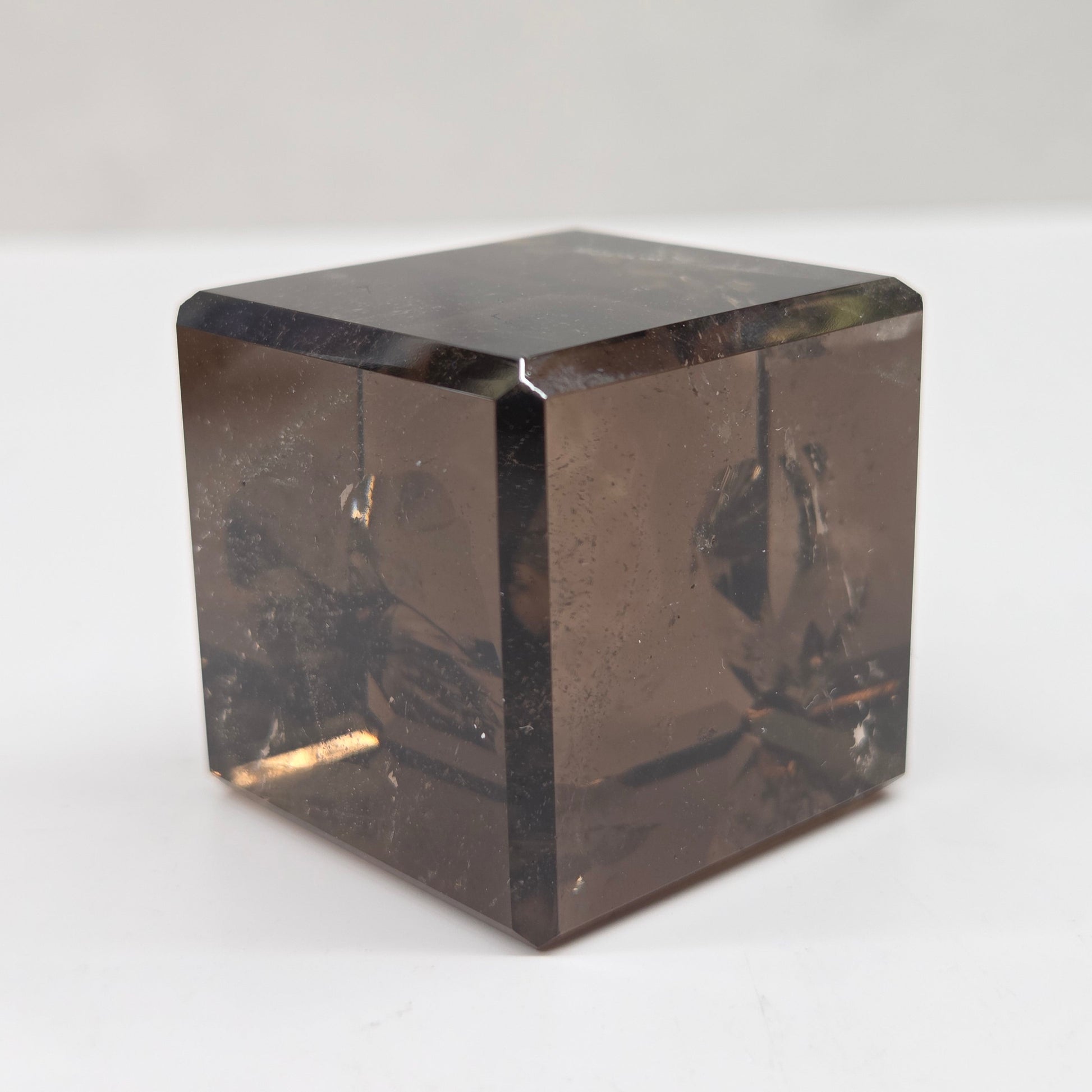 smoky quartz cube carving on a white background