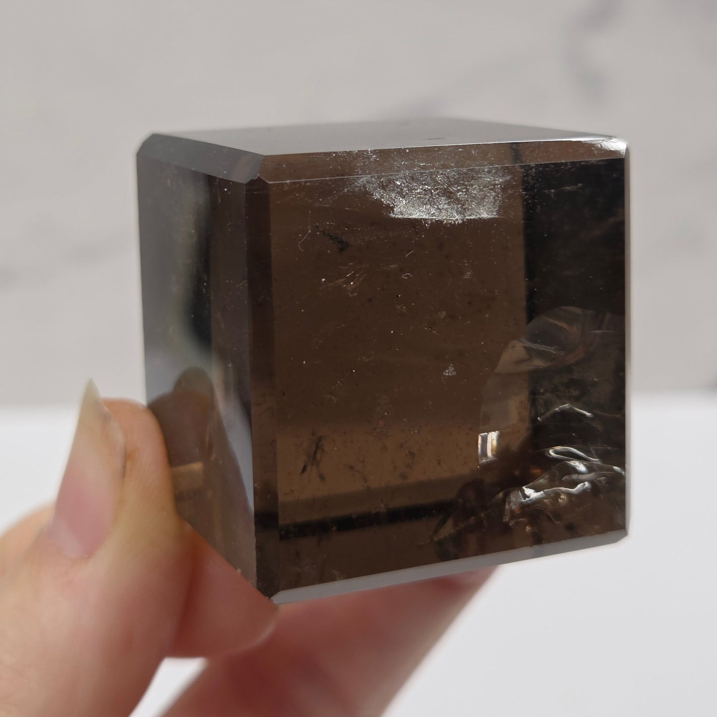 smoky quartz cube carving on a white background